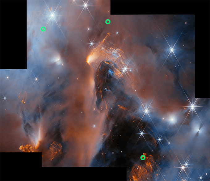 Stars and swirls of dust are visible in this composite image of a stellar nursery. Three green circles mark the locations of the baby worlds, the researchers say.